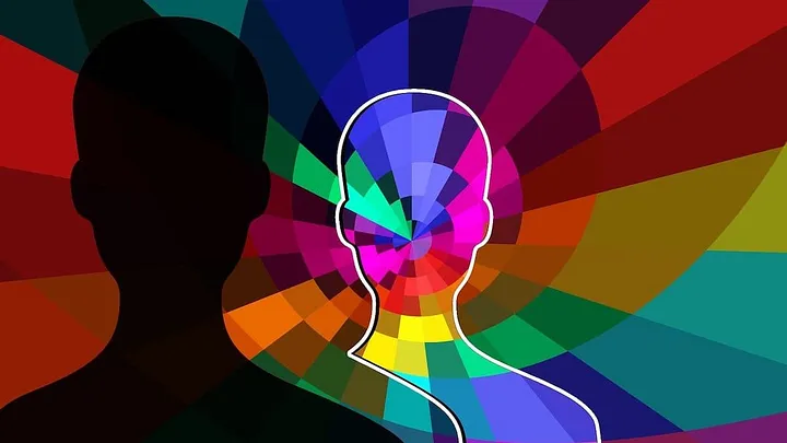 Human silhouette has a transparent shadow over a rainbow spiral background