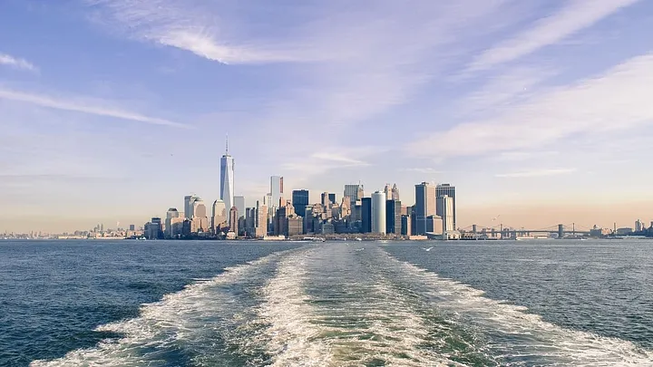 Boat wake showing New York City in the distance