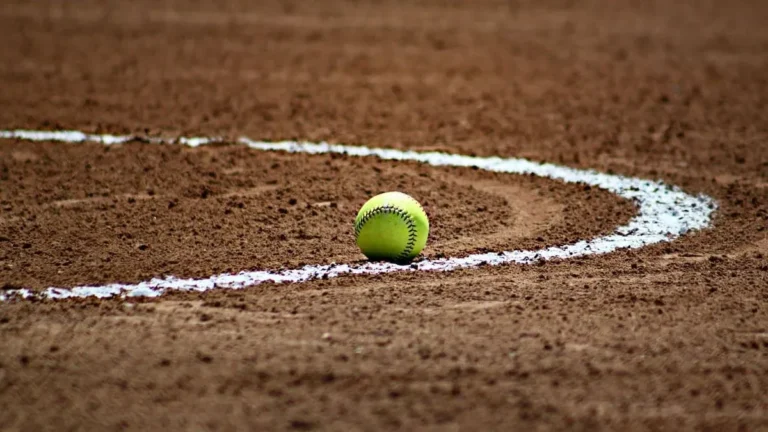 softball resting on a dirt field