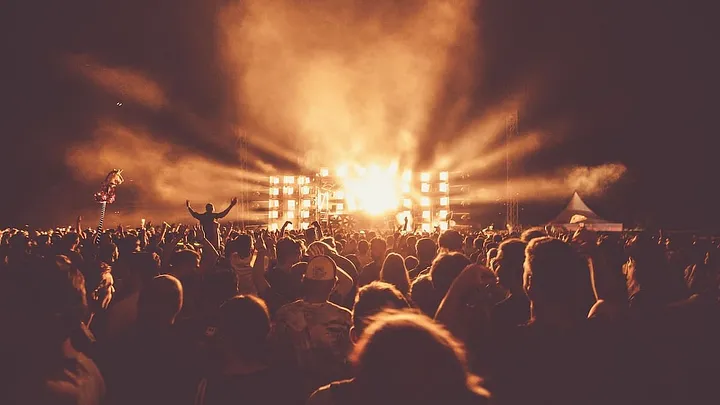 audience facing a glowing empty stage