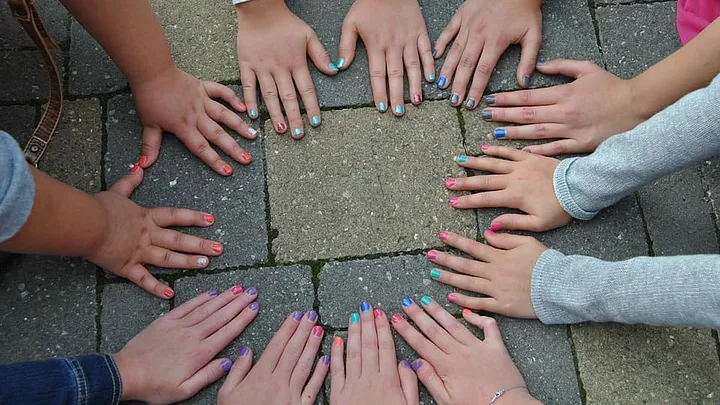 hands in a circle wtih painted fingernails