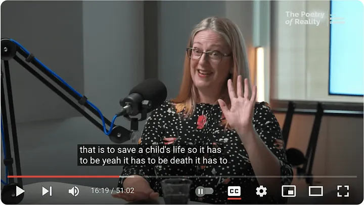 quirky video still of Helen Joyce putting her hand up and looking astonished with the closed caption: that is to save a child's life so it has to be yeah it has to be death it has to