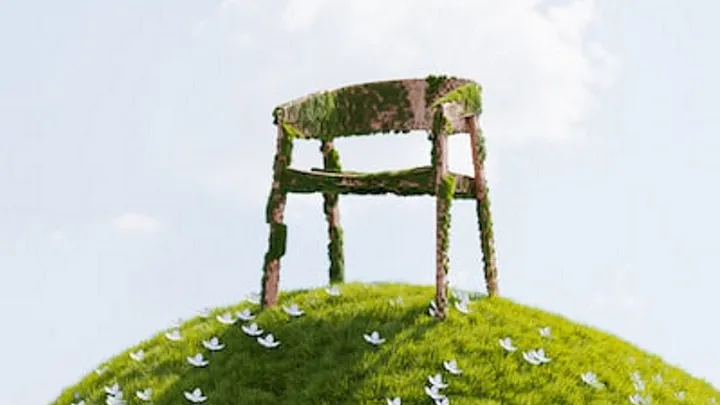 empty chair covered in moss on top of a hill