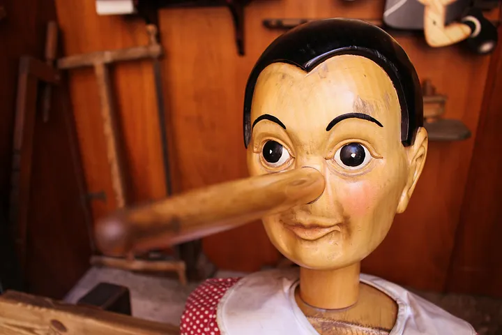 wooden Pinocchio doll with long nose, indicating (according to the story) that he has lied