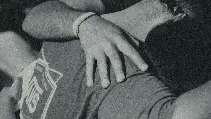 black-and-white photo closeup of a group hug