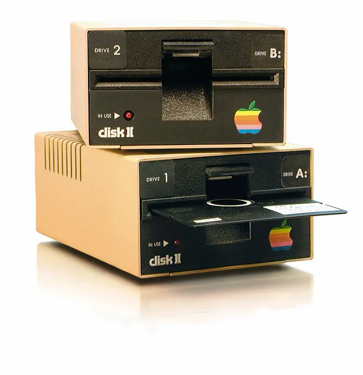 old Apple disk drive with a floppy disk sticking out